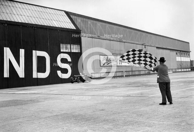 Waving the chequered flag at Brooklands, 1938 or 1939. Artist: Bill Brunell.