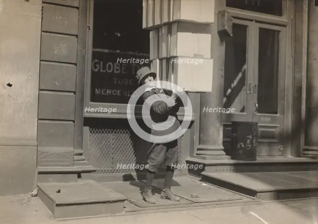 Wagon boy or "tail boy" helping to load the wagon, c. 1914. Creator: Lewis Wickes Hine.