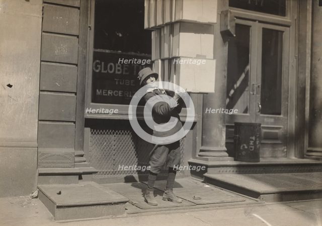 Wagon boy or "tail boy" helping to load the wagon, c. 1914. Creator: Lewis Wickes Hine.
