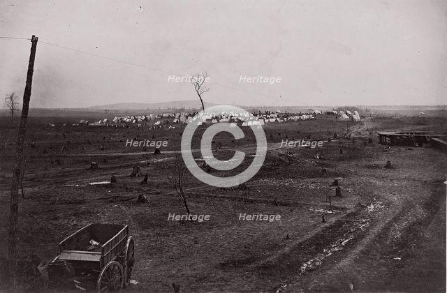 [Wagon in a landscape with army encampment in the distance]. Brady album, p. 125, 1861-65. Creator: Unknown.