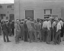 Waiting for the semi-monthly relief checks at Calipatria, California, 1937. Creator: Dorothea Lange