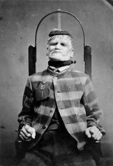 Wakefield Prison, Yorkshire: an elderly man, struggling against the restraint-chair in..., c1869. Creator: Unknown