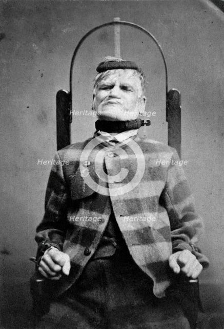 Wakefield Prison, Yorkshire: an elderly man, struggling against the restraint-chair in..., c1869. Creator: Unknown.