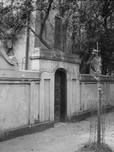 Wall with gate enclosing a building, New Orleans or Charleston, South Carolina, c1920-1926. Creator: Arnold Genthe
