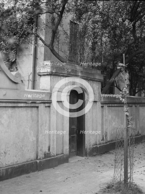 Wall with gate enclosing a building, New Orleans or Charleston, South Carolina, c1920-1926. Creator: Arnold Genthe.