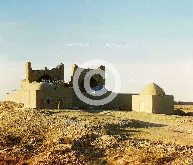 Walled adobe structure with domes and arches in desert area, with man posed..., between 1905-1915. Creator: Sergey Mikhaylovich Prokudin-Gorsky.