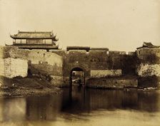 Walled River and Bridge with Buildings Above, 1860. Creator: Felice Beato