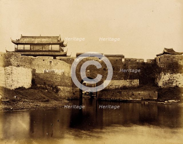 Walled River and Bridge with Buildings Above, 1860. Creator: Felice Beato.
