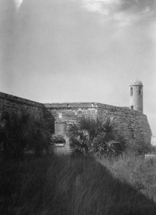 Walls and round tower by the water, Castillo de San Marcos, St. Augustine, Florida, c1920-c1926. Creator: Arnold Genthe