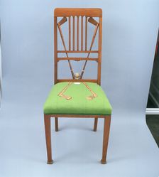Walnut dining chair incorporating golf clubs and a golf ball, 1920s. Creator: Unknown