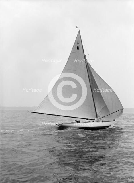 'Wamba II' running downwind under spinnaker, 1914. Creator: Kirk & Sons of Cowes.