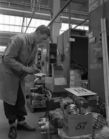 Warehouseman checking stock in the stores at Bestwood Colliery, North Nottinghamshire, 1962. Creator: Michael Walters