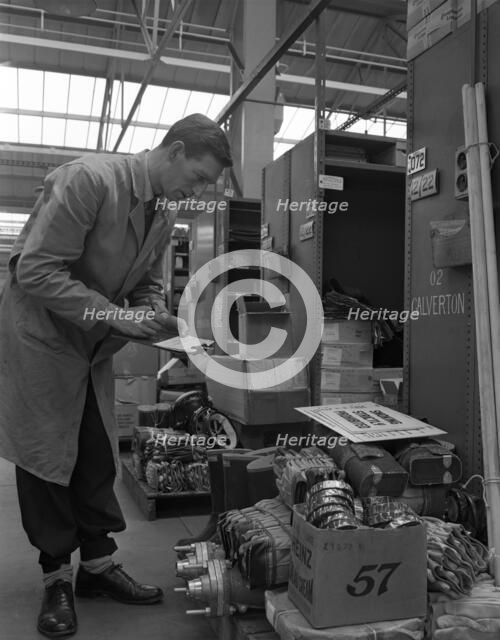 Warehouseman checking stock in the stores at Bestwood Colliery, North Nottinghamshire, 1962. Artist: Michael Walters