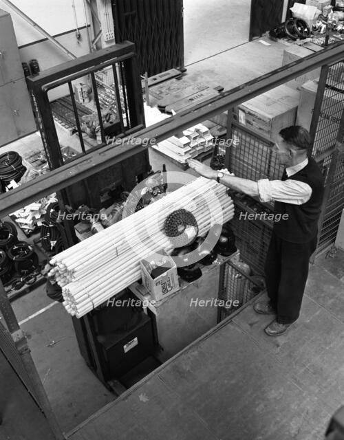 Warehouseman loading a fork lift truck in the stores, Bestwood Colliery, Nottinghamshire, 1962.  Artist: Michael Walters