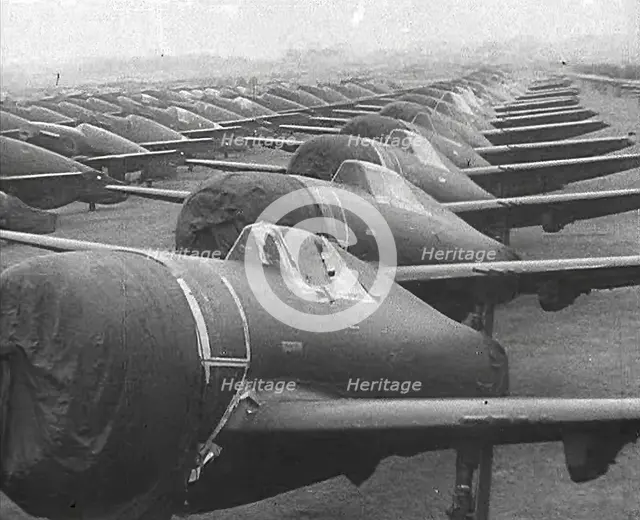Warplanes Sitting in an Airfield With Covers Over the Propellers, 1943-1944. Creator: British Pathe Ltd.