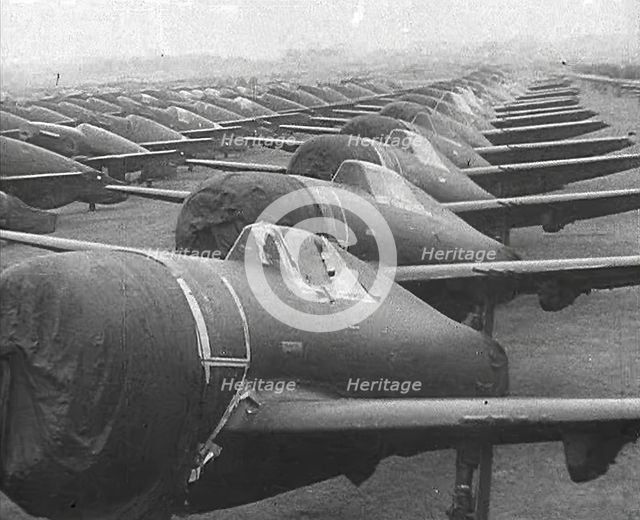 Warplanes Sitting in an Airfield With Covers Over the Propellers, 1943-1944. Creator: British Pathe Ltd.