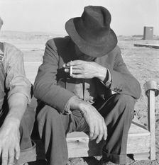 Was Nebraska farmer, now migrant farm worker in the West, Merrill, Klamath County, Oregon, 1939. Creator: Dorothea Lange