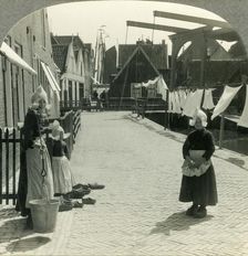 Washday in Volendam, Netherlands - Shoes Large and Small and Some Who Wear Them c1930s. Creator: Unknown