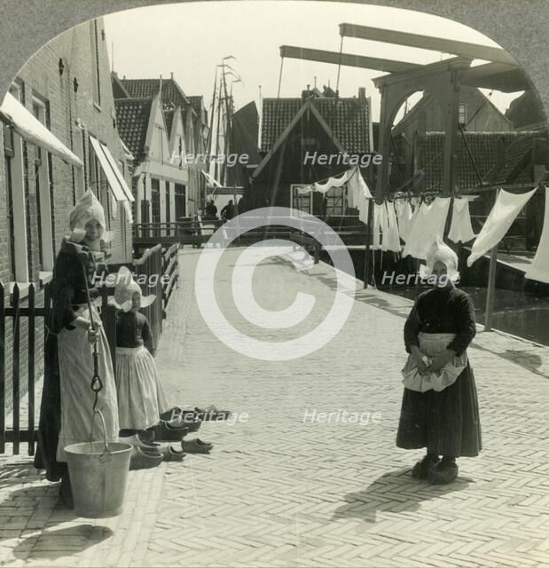 'Washday in Volendam, Netherlands - Shoes Large and Small and Some Who Wear Them', c1930s. Creator: Unknown.