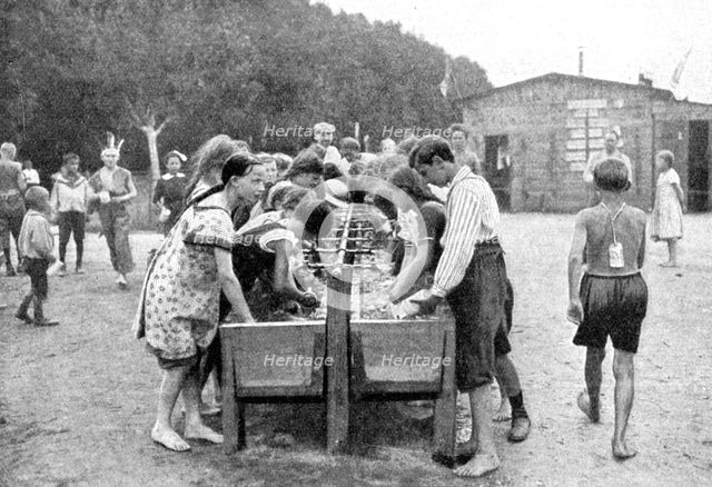 Washing-up at a juvenile summer holiday camp, Germany, 1922.Artist: Otto Haeckel