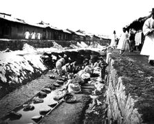 Washing clothes outdoors, Korea, 1900