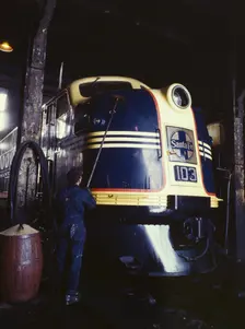 Washing one of the Santa Fe R.R. 54 hundred horse power diesel freight...,Argentine, Kansas, 1943. Creator: Jack Delano