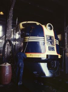 Washing one of the Santa Fe R.R. 54 hundred horse power diesel freight...,Argentine, Kansas, 1943. Creator: Jack Delano