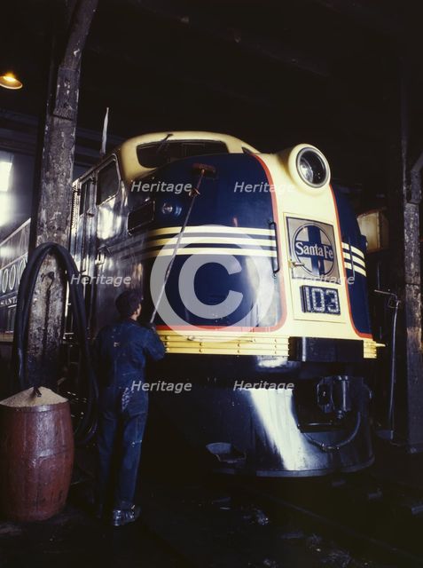 Washing one of the Santa Fe R.R. 54 hundred horse power diesel freight...,Argentine, Kansas, 1943. Creator: Jack Delano.