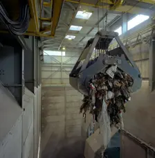 Waste ready for incineration in giant crane grab jaws, St Helier, Jersey, 1980. Creator: Michael Walters