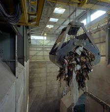 Waste ready for incineration in giant crane grab jaws, St Helier, Jersey, 1980. Creator: Michael Walters