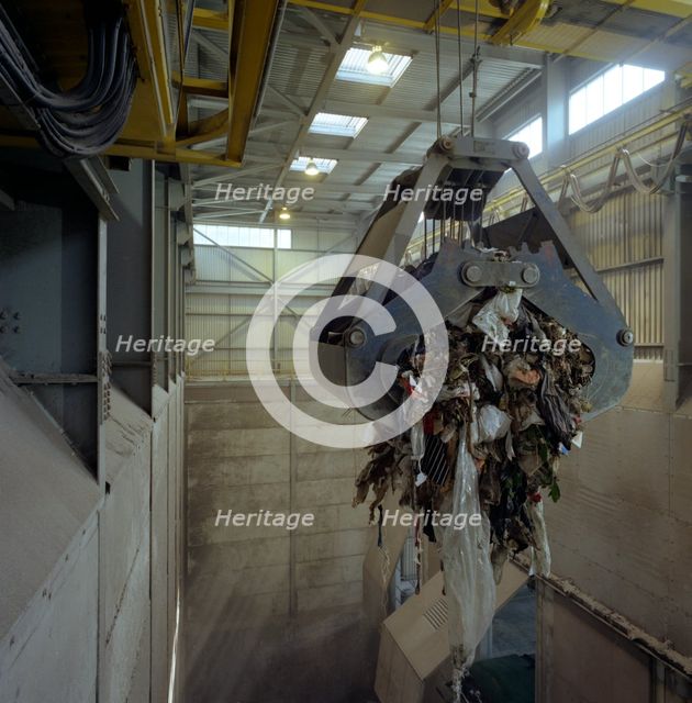 Waste ready for incineration in giant crane grab jaws, St Helier, Jersey, 1980.  Creator: Michael Walters.