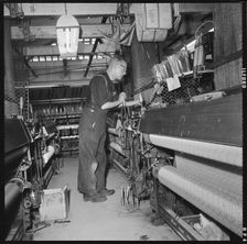 Weaver operating a Jacquard power loom, 1966-1974. Creator: Eileen Deste