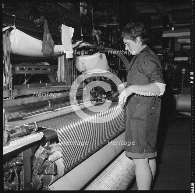 Weaver preparing a shuttle for use in a power loom, 1966-1974. Creator: Eileen Deste.