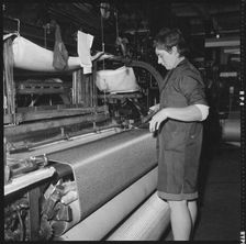 Weaver preparing a shuttle for use in a power loom, 1966-1974. Creator: Eileen Deste