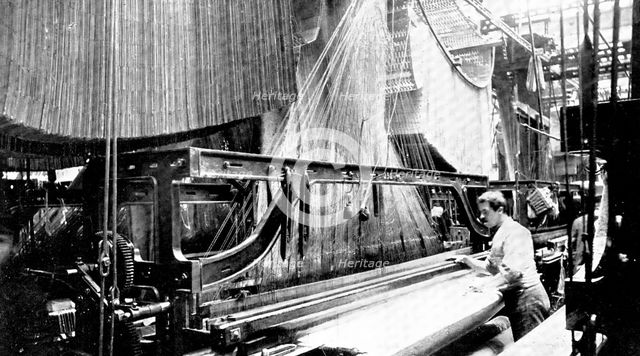Weaving three-yard-wide quilts: a large jacquard loom in use, 1909. Creator: Unknown.