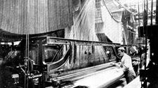 Weaving three-yard-wide quilts: a large jacquard loom in use, 1909. Creator: Unknown