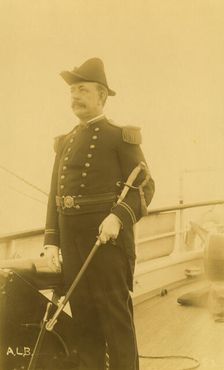 "Webber," a naval officer or ship captain, three-quarter length portrait, standing...,1894 or 95. Creator: Alfred Lee Broadbent