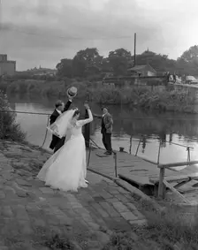 Wedding couple crossing the river Don, Mexborough, South Yorkshire, 1961. Creator: Michael Walters