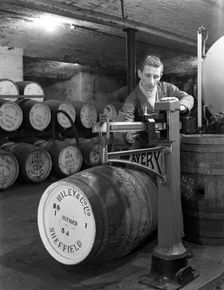 Weighing barrels of blended whisky at Wiley & Co, Sheffield, South Yorkshire, 1960. Creator: Michael Walters
