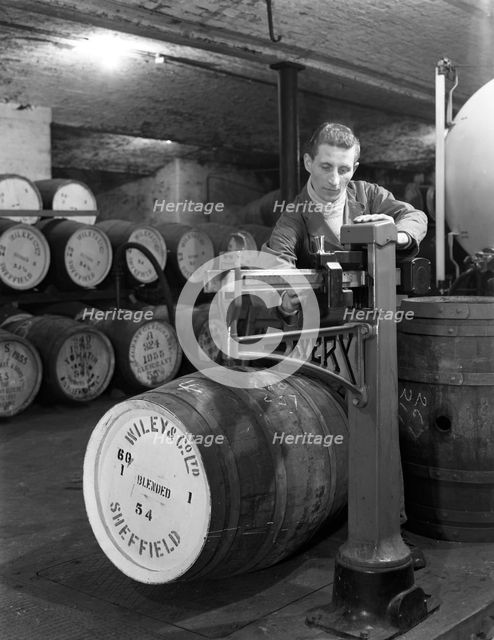 Weighing barrels of blended whisky at Wiley & Co, Sheffield, South Yorkshire, 1960. Creator: Michael Walters.