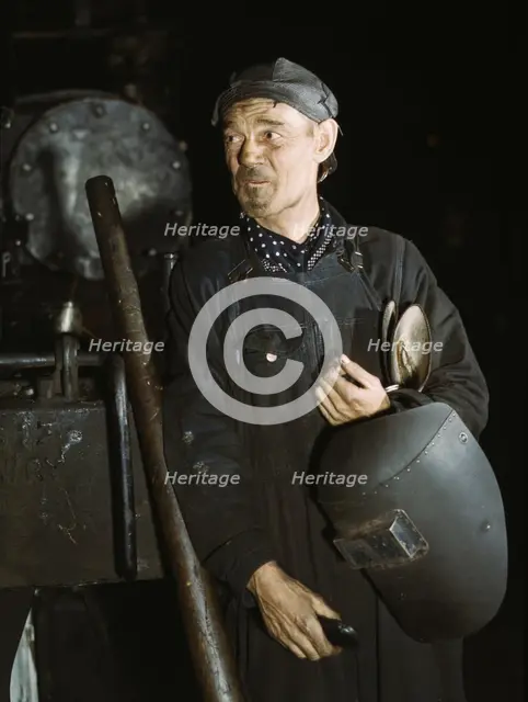Welder at the C & NW RR locomotive shops, 40th Street shops, Chicago, Ill., 1942. Creator: Jack Delano.