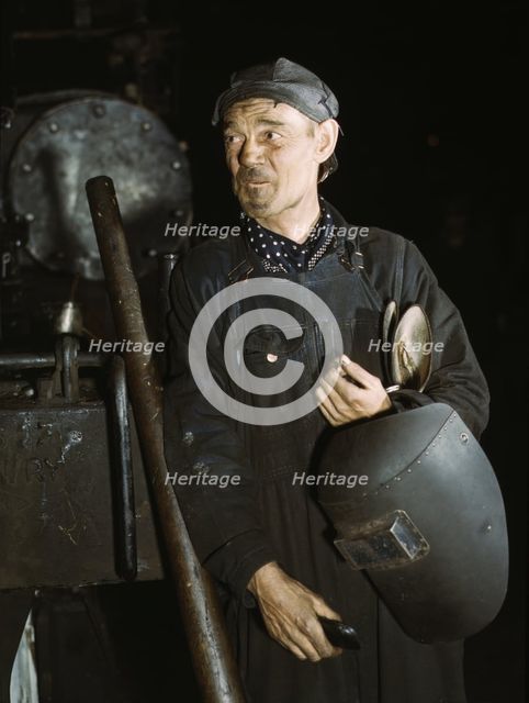 Welder at the C & NW RR locomotive shops, 40th Street shops, Chicago, Ill., 1942. Creator: Jack Delano.