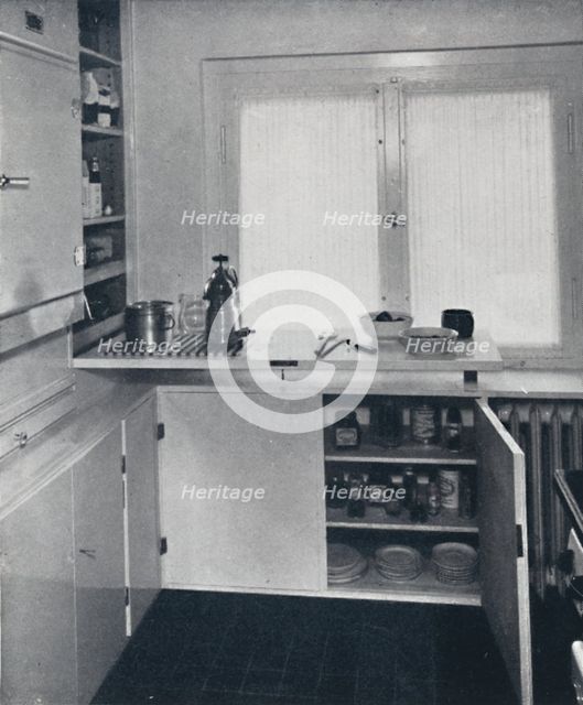 'Werner Harting - Kitchen with a black Dutch tiled floor, white walls and built-in shelves and cupbo Artist: Unknown.