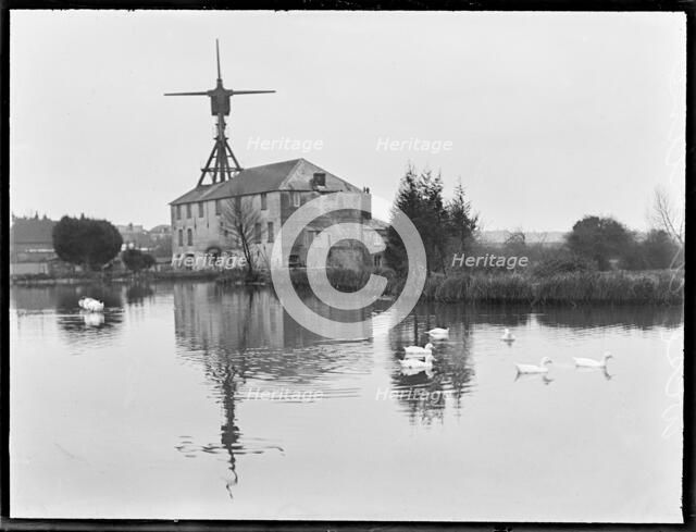 West Ashling Mill from north-west across the mill pond, Mill Road, Funtington, West Sussex, 1920-50. Creator: George R Long.