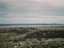 West-bound passenger train going around a curve on the Atchison..., near Gleed, Arizona, 1943. Creator: Jack Delano