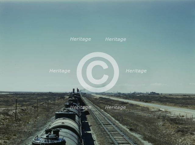 West bound Santa Fe R.R. freight train stopping for water, Tolar, New Mexico, 1943. Creator: Jack Delano.