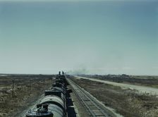 West bound Santa Fe R.R. freight train stopping for water, Tolar, New Mexico, 1943. Creator: Jack Delano