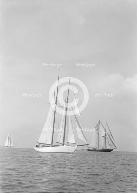 'Westward' (foreground) and the visiting Canadian schooner 'Bluenose', 1935. Creator: Kirk & Sons of Cowes.