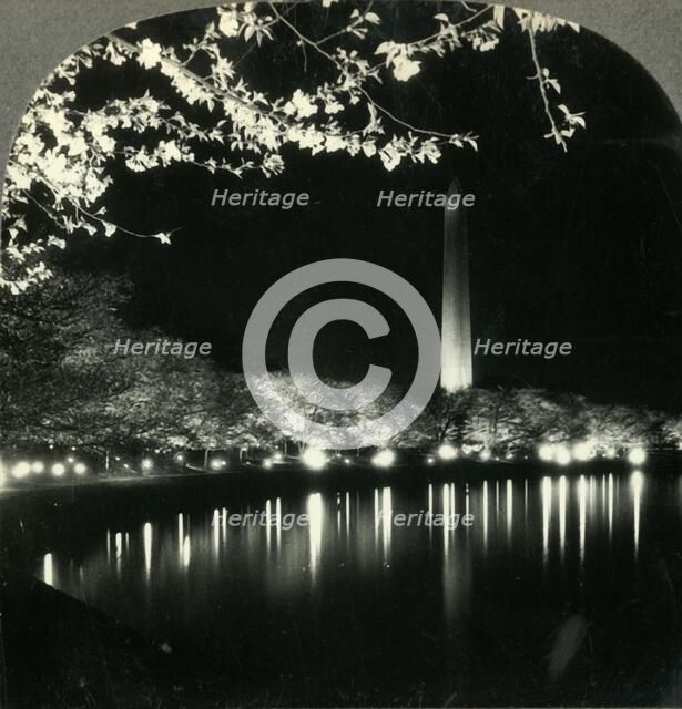'When It Is Cherry Blossom Time in Washington - A Lovely Night View of Washington Monument', c1930s. Creator: Unknown.