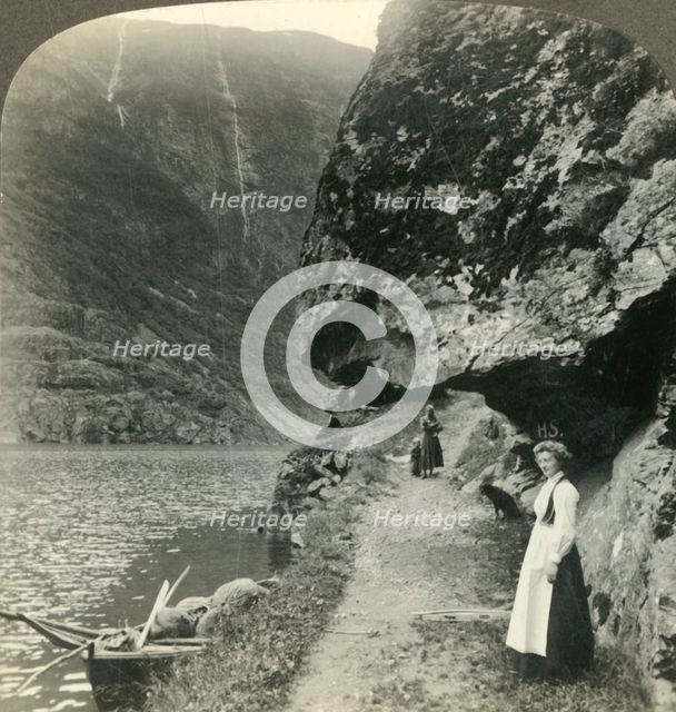'Where the road creeps under the jutting cliffs by the waters of the Nerofjord, Norway', c1905. Creator: Unknown.
